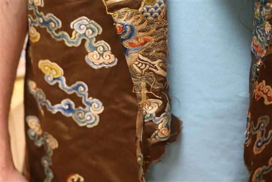 A Chinese black ground polychrome silk embroidered robe (a.f.)